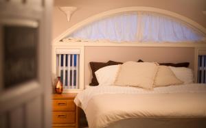 a bedroom with a white bed with a window at Eagle Close Executive B&B in Prince Rupert +16 photos