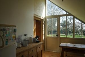 cocina con nevera y ventana en Les communs du manoir, en Loc-Maria-Plouzané