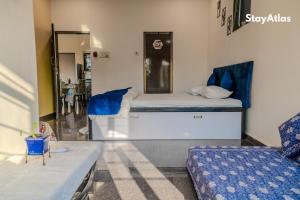 a bedroom with a bed and a couch and a mirror at Sierra Sky Villa in Igatpuri +48 photos