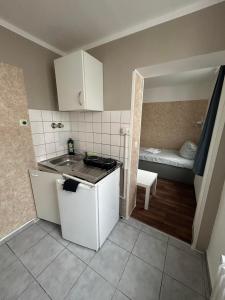 a small kitchen with a sink and a room at 2-Rent Group Hostel Apartments SEN14 in Munich +249 photos