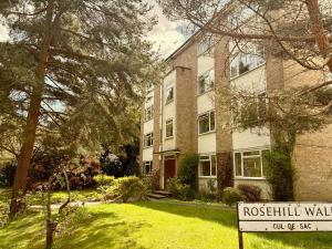 a brick building with a sign in front of it at Rosehill Walk Peaceful Ground Floor Home in Central Tunbridge Wells in Royal Tunbridge Wells
