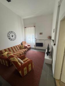 a living room with two couches and a tv at Downtown Apartment in Pápa