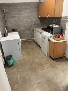 a kitchen with a sink and a stove at Downtown Apartment in Pápa