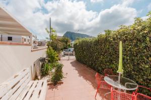 a patio with a table and chairs and a fence at A_mare San Vito Lo Capo in San Vito lo Capo