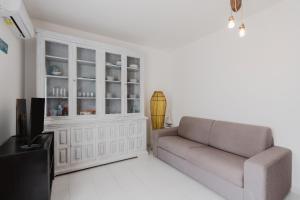a living room with a couch and a tv at A_mare San Vito Lo Capo in San Vito lo Capo