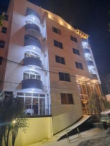 a building with lights on top of it at night at Park Lane Addis Hotel in Addis Ababa
