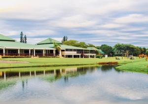 a building with a pond in front of it at Cosy Urban Apartment in Durban