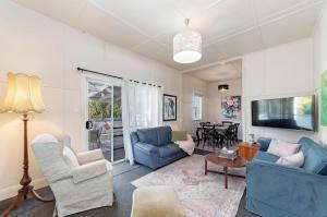 a living room with two blue chairs and a table at Seafield in Port Fairy