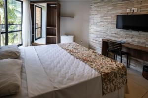 Postel nebo postele na pokoji v ubytování Bessa Beach Hotel
