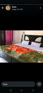 a picture of a bed with orange flowers on it at Om som home stay hill view in Jāmb