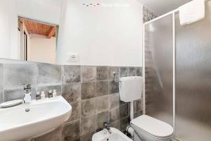 a bathroom with a sink and a toilet and a shower at La Grotta in Vernazza