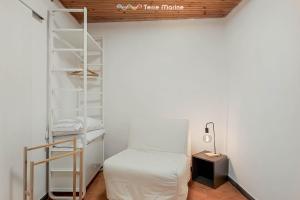 a small room with a ladder and a bed at La Grotta in Vernazza +7 photos