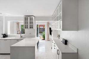 a kitchen with white counters and white cabinets at Tower Bridge City Residence King En-suite With Parking in London