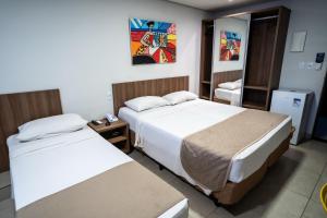 Postel nebo postele na pokoji v ubytování Bessa Beach Hotel