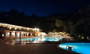 a resort with a pool at night at La grande terrazza di Capo d'Arco in Capo D'Arco