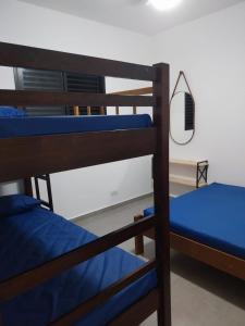 a pair of bunk beds in a room at lindo apartamento martim de sá 2 dormitórios wi fi piscina pé na areia 32 b in Caraguatatuba +48 photos