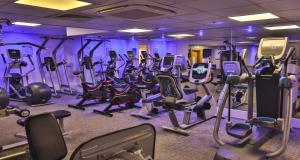 a gym with rows of exercise equipment in a purple room at Glasgow Argyle Hotel, BW Signature Collection in Glasgow