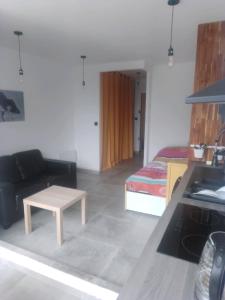 een woonkamer met een bed en een salontafel bij Les Appartements De Lina - Trianon 38 - Self Check-In - in La Grande-Motte