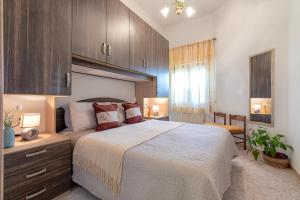a bedroom with a large bed and wooden cabinets at Viviana's Holiday Home in Trinità dʼAgultu