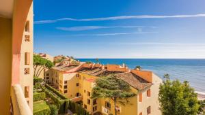 a view of the ocean from a building at Macdonald Doña Lola Resort in La Cala de Mijas