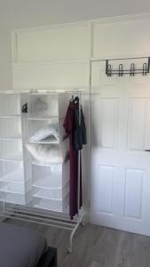 a closet with a glass door next to a room with a closet at A house near Etihad and Manchester town centre in Manchester