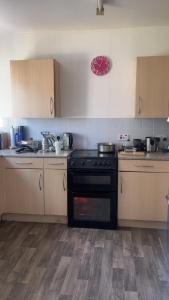 a kitchen with a stove top oven in a kitchen at A house near Etihad and Manchester town centre in Manchester
