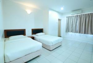 Voodi või voodid majutusasutuse Mersing Hotel toas