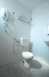 a bathroom with a toilet and a shower at Mersing Hotel in Mersing