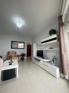a living room with a couch and a table at Apartamento con piscina Torremolinos in Torremolinos