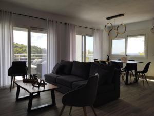 a living room with a couch and a table at D & A Land luxury house in Alonnisos