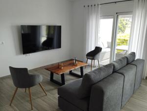 a living room with a couch and a table at D & A Land luxury house in Alonnisos