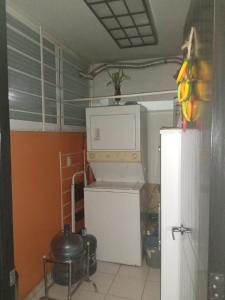 a kitchen with a refrigerator and a microwave at Depa amueblado y Bonita in Buenavista