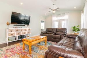 a living room with a couch and a coffee table at Flamingo Hideaway Modern House w Elevator in Myrtle Beach