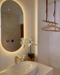 Un baño con un lavabo blanco y un espejo. en The Deer Head Inn, en Kenting