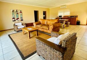 a living room with a couch and a table at Travalia Guest Farm in Nelspoort