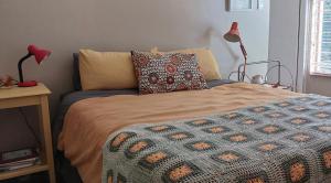 a bed with two pillows on it in a bedroom at Braemar House Howick in Howick