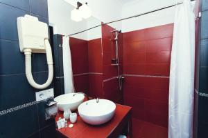 a bathroom with a toilet and a sink at Shadow Boutique Hotel & Spa in Chişinău