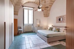 a bedroom with a bed and a ceiling fan at Sardinia 10 Apartment - Lecce Selection in Lecce