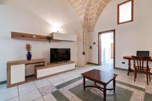 a living room with a tv and a table at Sardinia 10 Apartment - Lecce Selection in Lecce