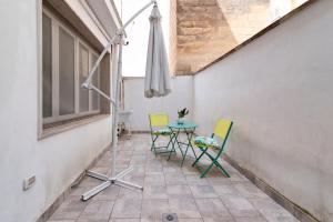 a patio with a table and chairs and an umbrella at Sardinia 10 Apartment - Lecce Selection in Lecce