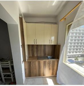 a kitchen with wooden cabinets in a room at Everest in Golem