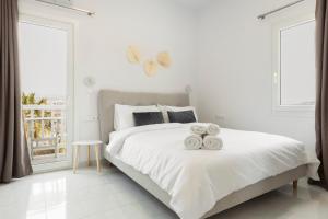 a bedroom with a bed with two towels on it at Mykonos Eight in Mikonos