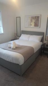 a bedroom with a large bed with white sheets and pillows at South Shields Executive Apartment in South Shields