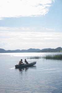two people in a boat in the water at Unik fjøsleilighet in Levanger