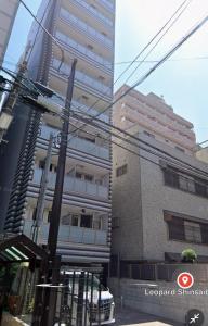 a tall building with a car parked in front of it at Leopard Shinsaibashi 心斎橋 505 in Osaka