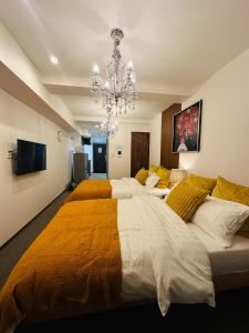 a large bedroom with two beds and a chandelier at Leopard Shinsaibashi 心斎橋 505 in Osaka +22 photos