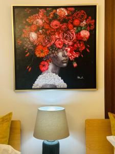 a painting of a woman with flowers on the wall at Leopard Shinsaibashi 心斎橋 505 in Osaka