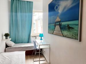 a living room with a table and a window at Hostel 44 in Sopot