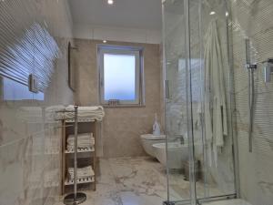 a bathroom with a shower and a toilet and a sink at La Casa di Mimi in Monopoli +25 photos