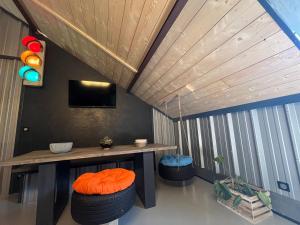 a room with a table and two stools and a tv at Le Garage in Luz-Saint-Sauveur